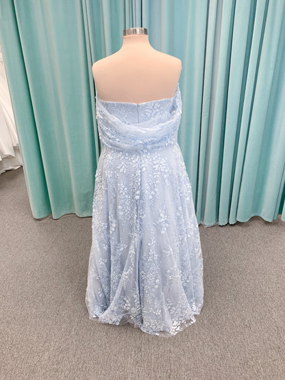 Morilee MLNY 73101 A-line mother of the bride dress on mannequin with strapless sweetheart neckline, detachable off-the-shoulder drape, 3D floral bodice, layered floral lace appliques, and full tulle skirt with pockets