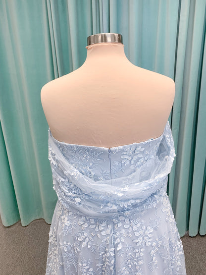 Morilee MLNY 73101 A-line mother of the bride dress on mannequin with strapless sweetheart neckline, detachable off-the-shoulder drape, 3D floral bodice, layered floral lace appliques, and full tulle skirt with pockets
