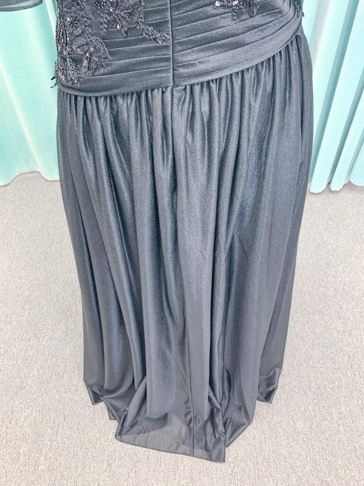 Morilee MLNY 73102 plus size A-line mother of the bride dress on mannequin with asymmetrically draped V-neck bodice, flutter sleeves, embroidered beaded appliques, and shimmer mesh A-line skirt