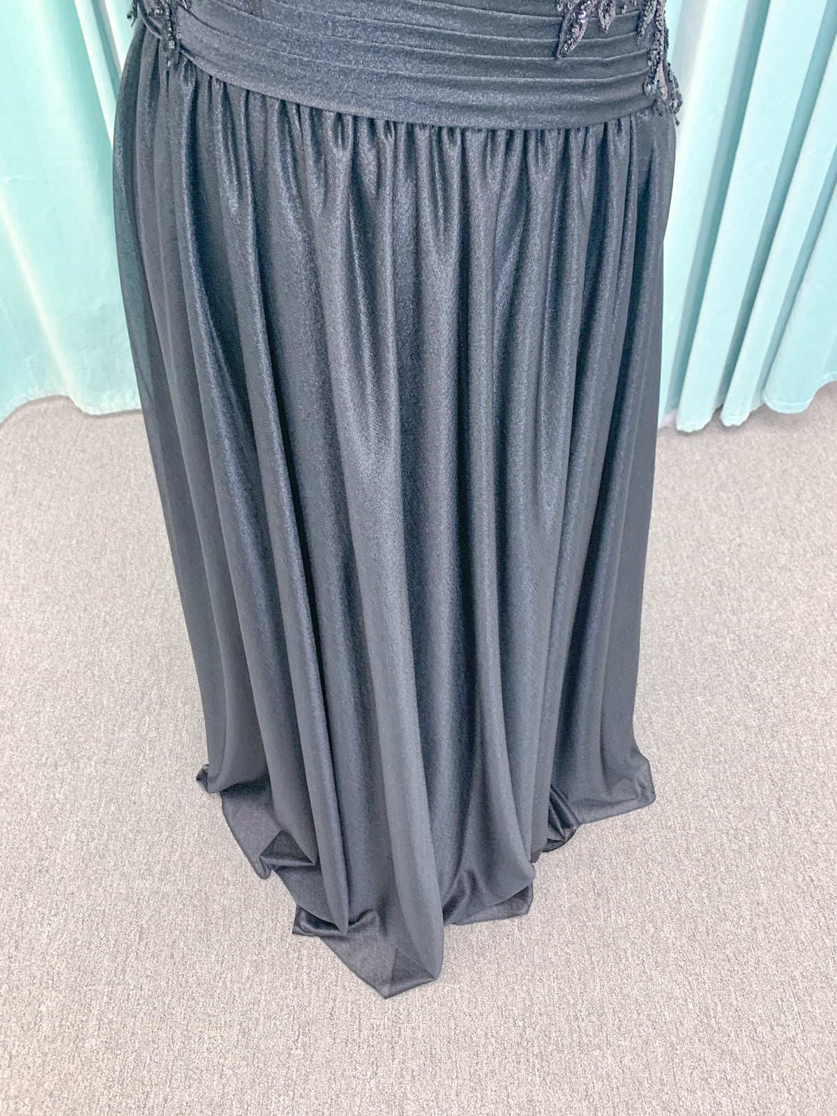 Morilee MLNY 73102 plus size A-line mother of the bride dress on mannequin with asymmetrically draped V-neck bodice, flutter sleeves, embroidered beaded appliques, and shimmer mesh A-line skirt