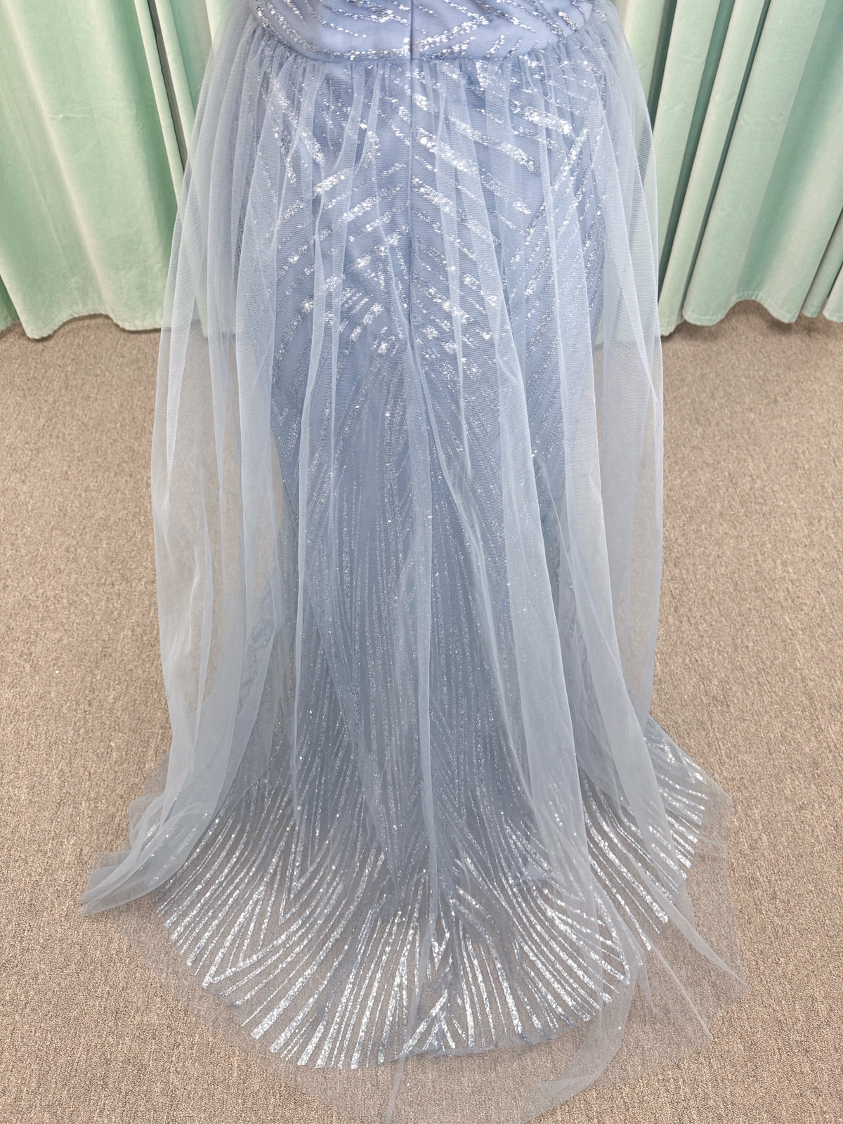 Morilee MLNY 73110 mermaid mother of the bride dress on mannequin with off-the-shoulder sweetheart neckline with foldover cuff, sequin-beaded net bodice, sheer tulle back panel, and sweep train