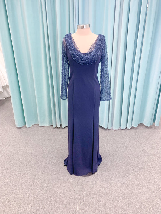 Morilee MLNY 73156 sheath mother of the bride dress on mannequin with cowl neckline, sheer long sleeves, beaded embellishments, sculpted crepe skirt, and thigh-high slit