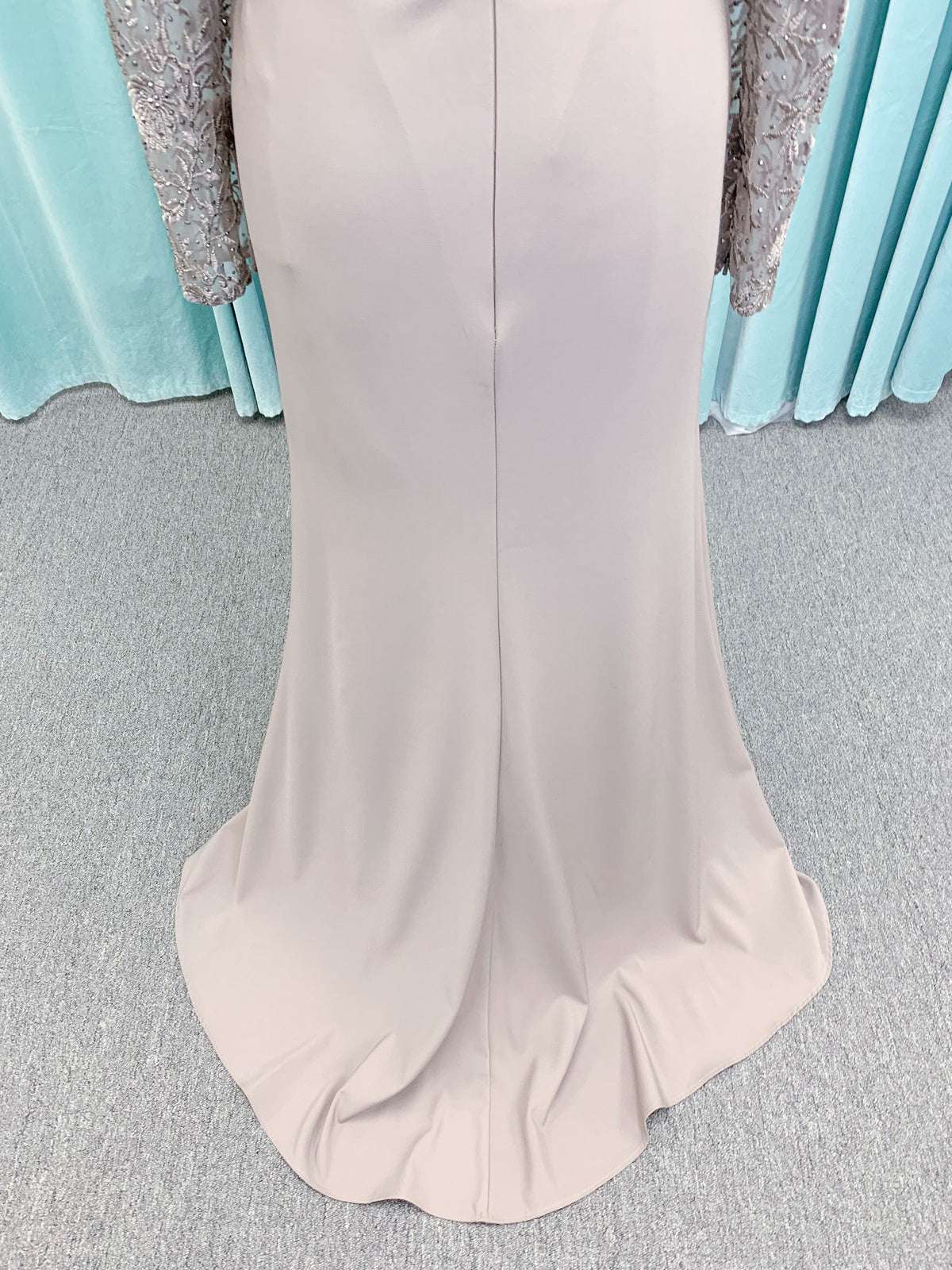 Morilee MLNY 73160 sheath mother of the bride dress on mannequin with modified sweetheart neckline, draped crepe bodice, sheer illusion long sleeves with lace applique, detachable beaded belt, and keyhole back