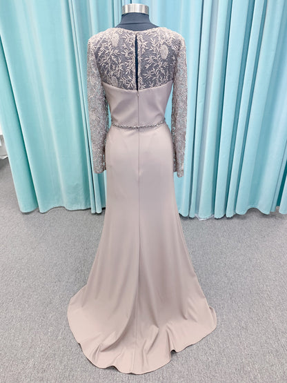 Morilee MLNY 73160 sheath mother of the bride dress on mannequin with modified sweetheart neckline, draped crepe bodice, sheer illusion long sleeves with lace applique, detachable beaded belt, and keyhole back