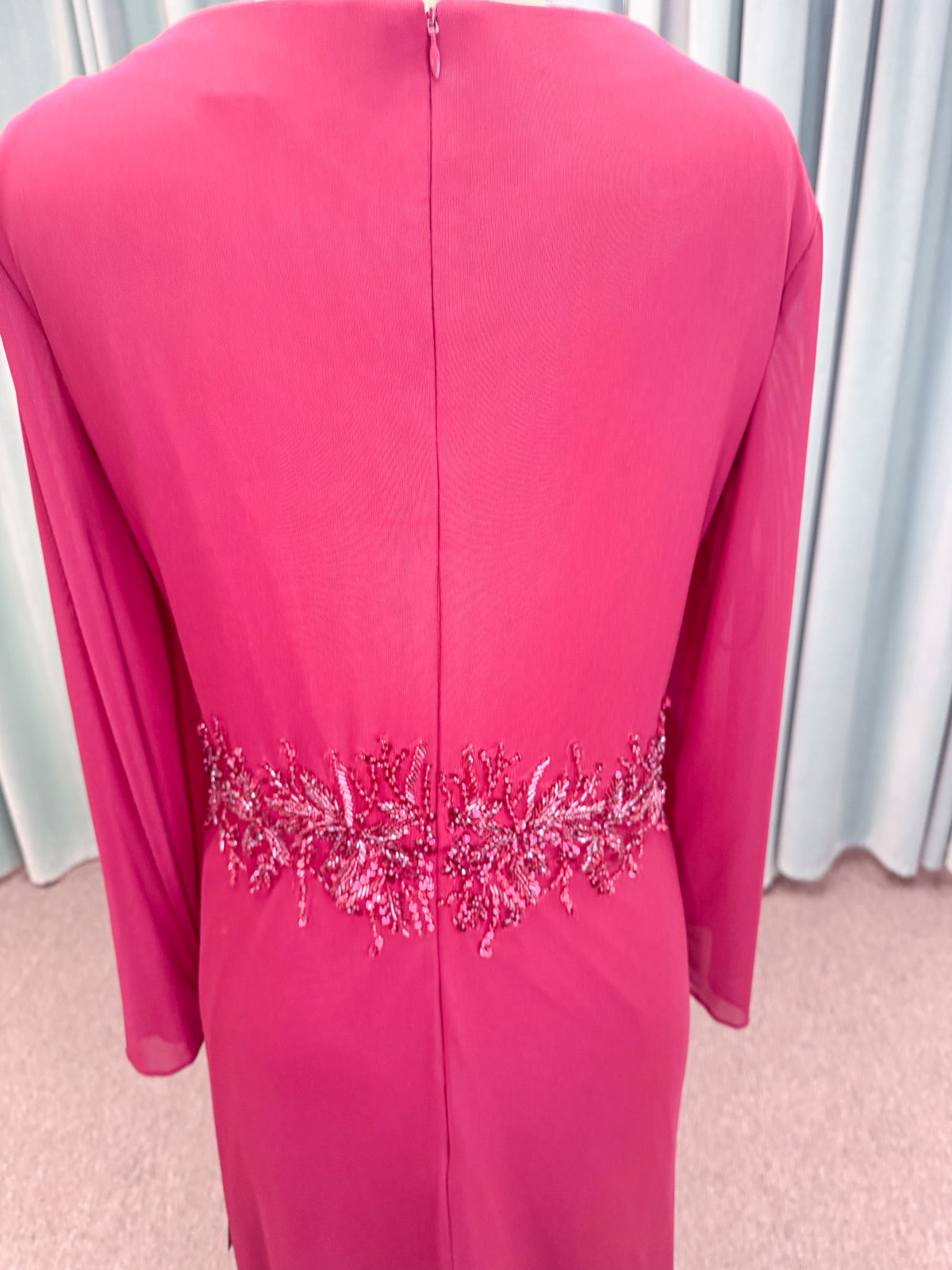 Morilee MLNY 73175 fit and flare mother of the bride dress on mannequin with draped V-neckline, long sleeves, beaded appliques, beaded waist, and slit skirt
