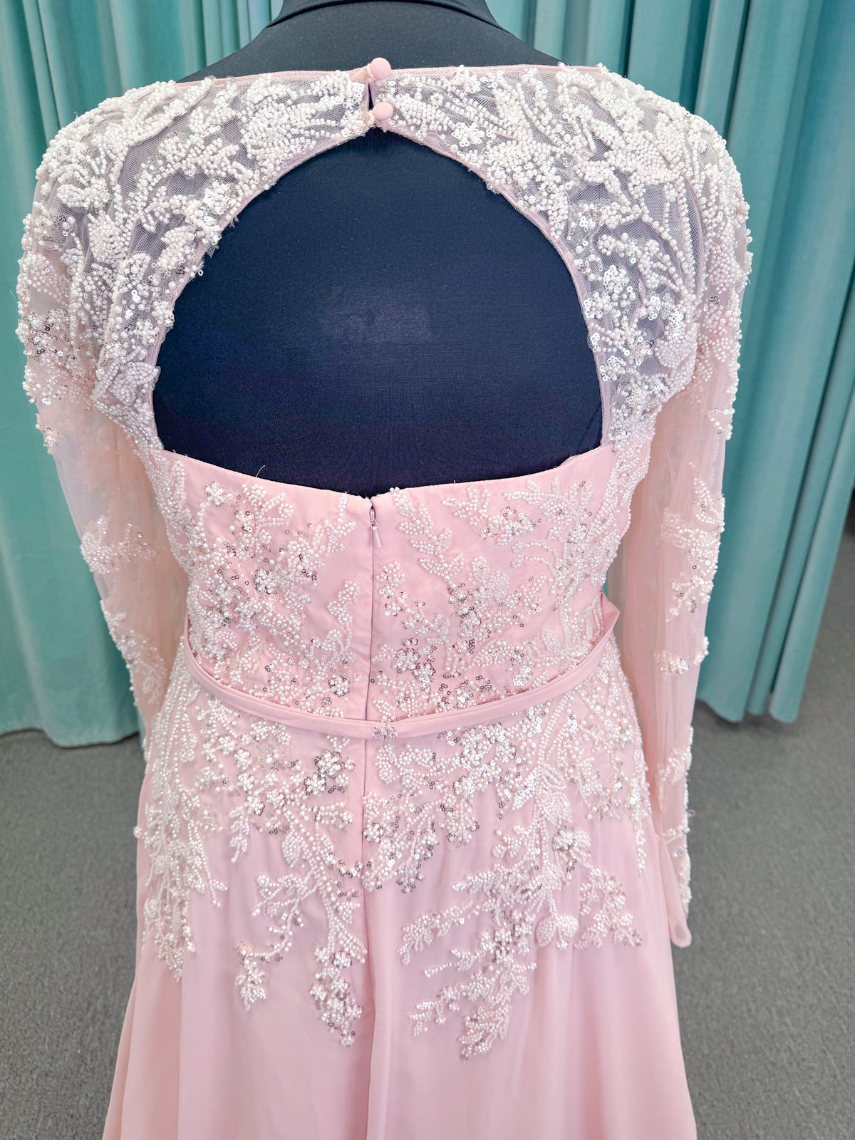  Morilee MLNY 73185 plus size A-line mother of the bride dress on mannequin with square neckline, draped chiffon bodice, sheer illusion long sleeves, beaded appliques, detachable self-belt, and flowing A-line skirt