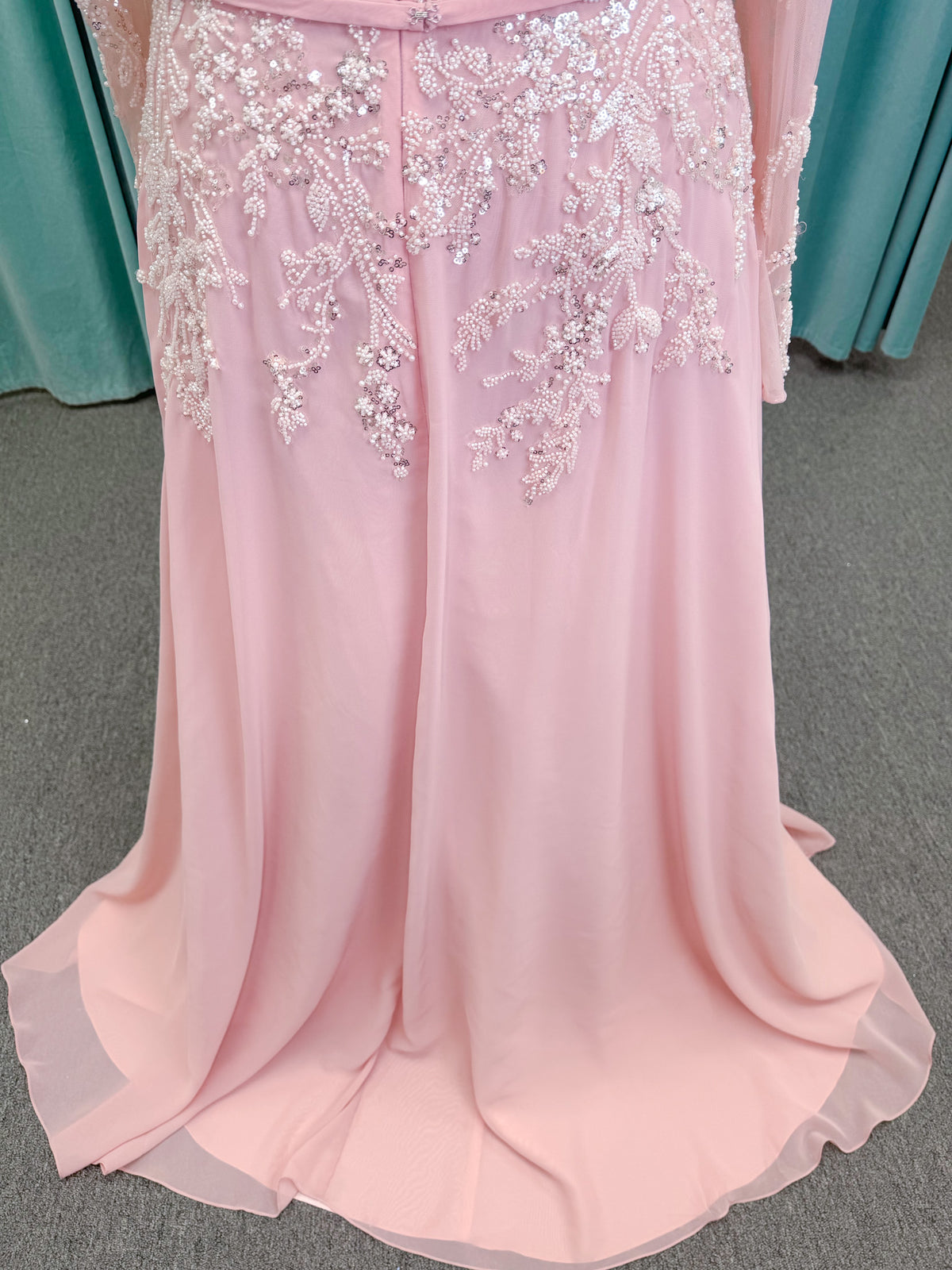  Morilee MLNY 73185 plus size A-line mother of the bride dress on mannequin with square neckline, draped chiffon bodice, sheer illusion long sleeves, beaded appliques, detachable self-belt, and flowing A-line skirt