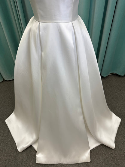 Achelios ivory strapless sweetheart satin ballgown wedding dress on mannequin with full skirt and clean structured bodice.
