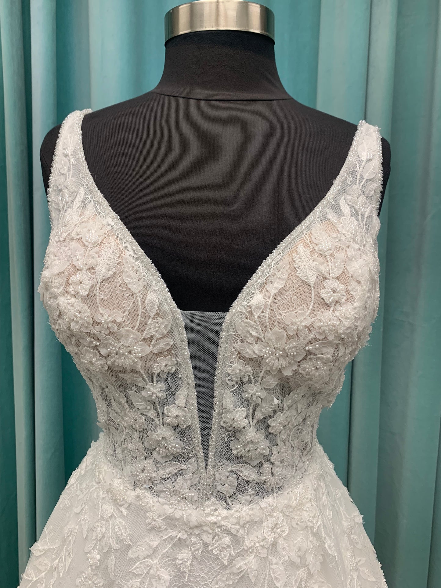 Morilee Style 2736 botanical A-line wedding dress with plunging v-neckline, beaded trim, 3D embroidered lace over Chantilly lace, and open v-back