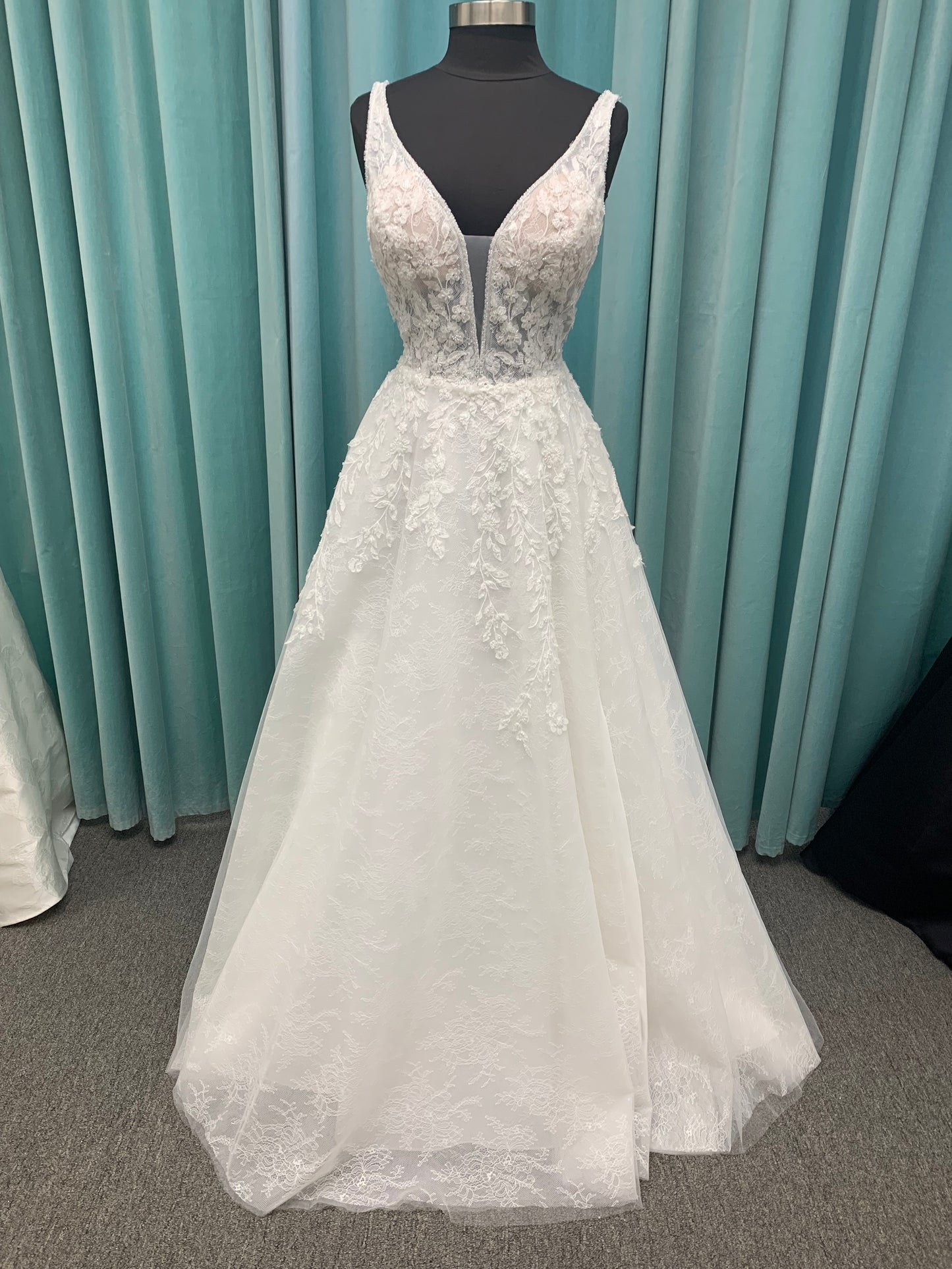 Morilee Style 2736 botanical A-line wedding dress with plunging v-neckline, beaded trim, 3D embroidered lace over Chantilly lace, and open v-back