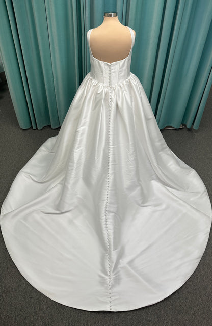 Essense of Australia D4145 ivory Mikado ballgown wedding dress on mannequin with strapless square neckline, basque waistline, and voluminous pleated skirt.

