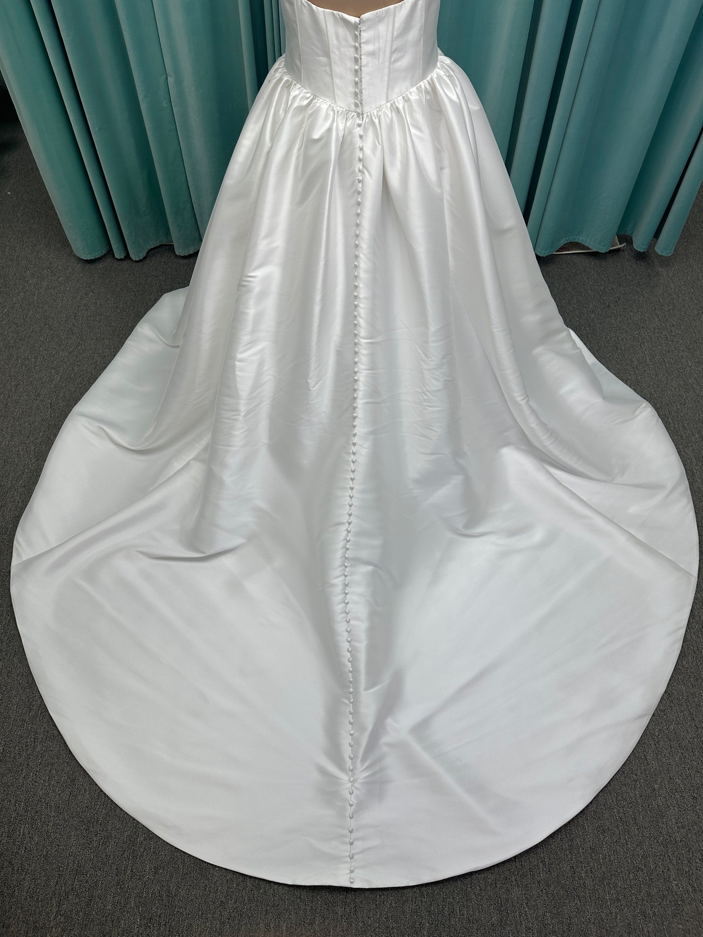 Essense of Australia D4145 ivory Mikado ballgown wedding dress on mannequin with strapless square neckline, basque waistline, and voluminous pleated skirt.
