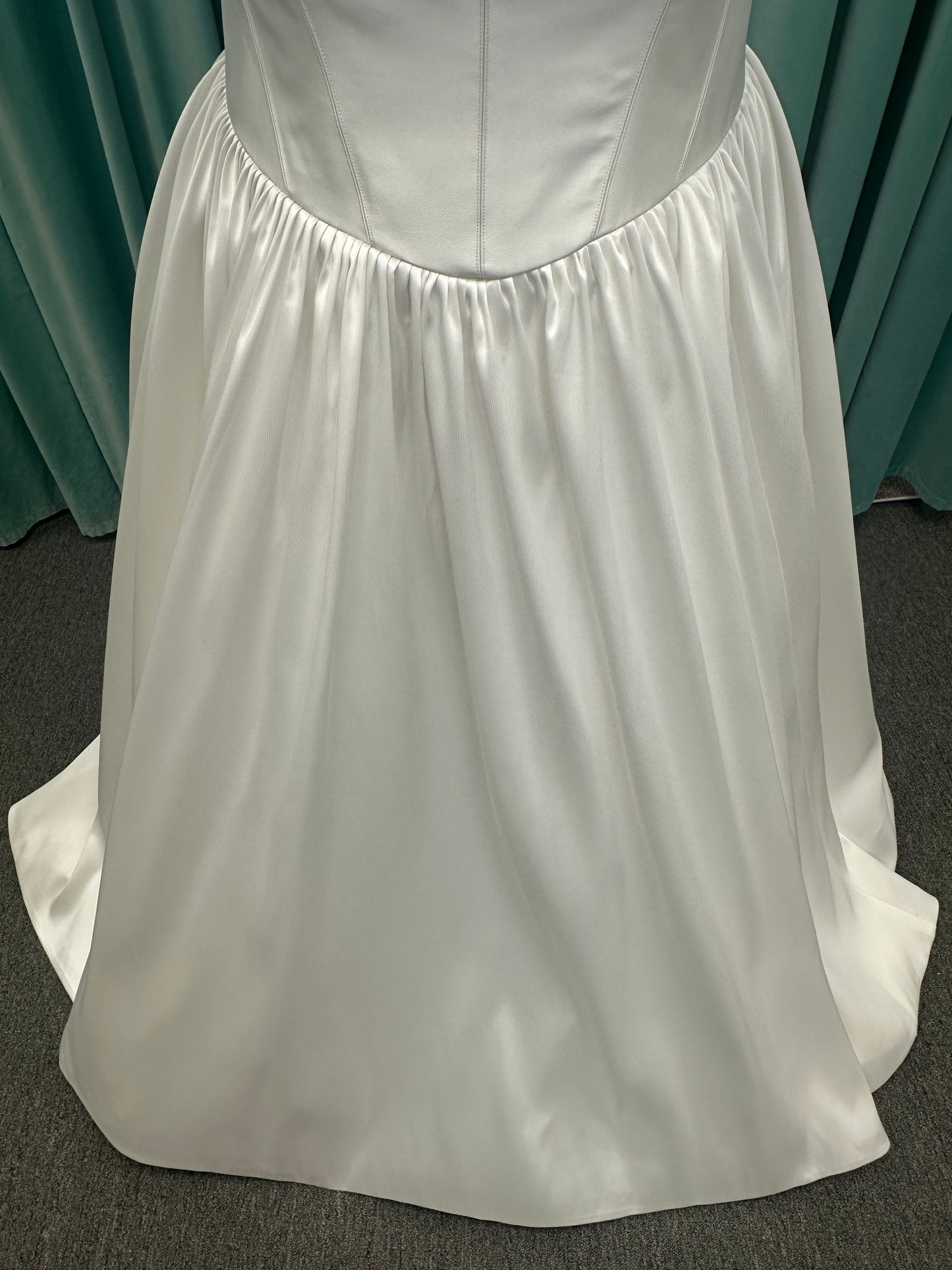 Essense of Australia D4145 ivory Mikado ballgown wedding dress on mannequin with strapless square neckline, basque waistline, and voluminous pleated skirt.

