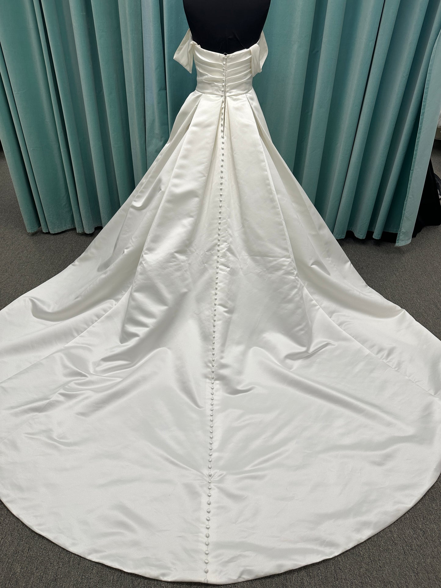 Off-the-shoulder satin A-line wedding dress with detachable straps, leg slit, pockets, and embroidered floral detailing by Essense of Australia style D4187