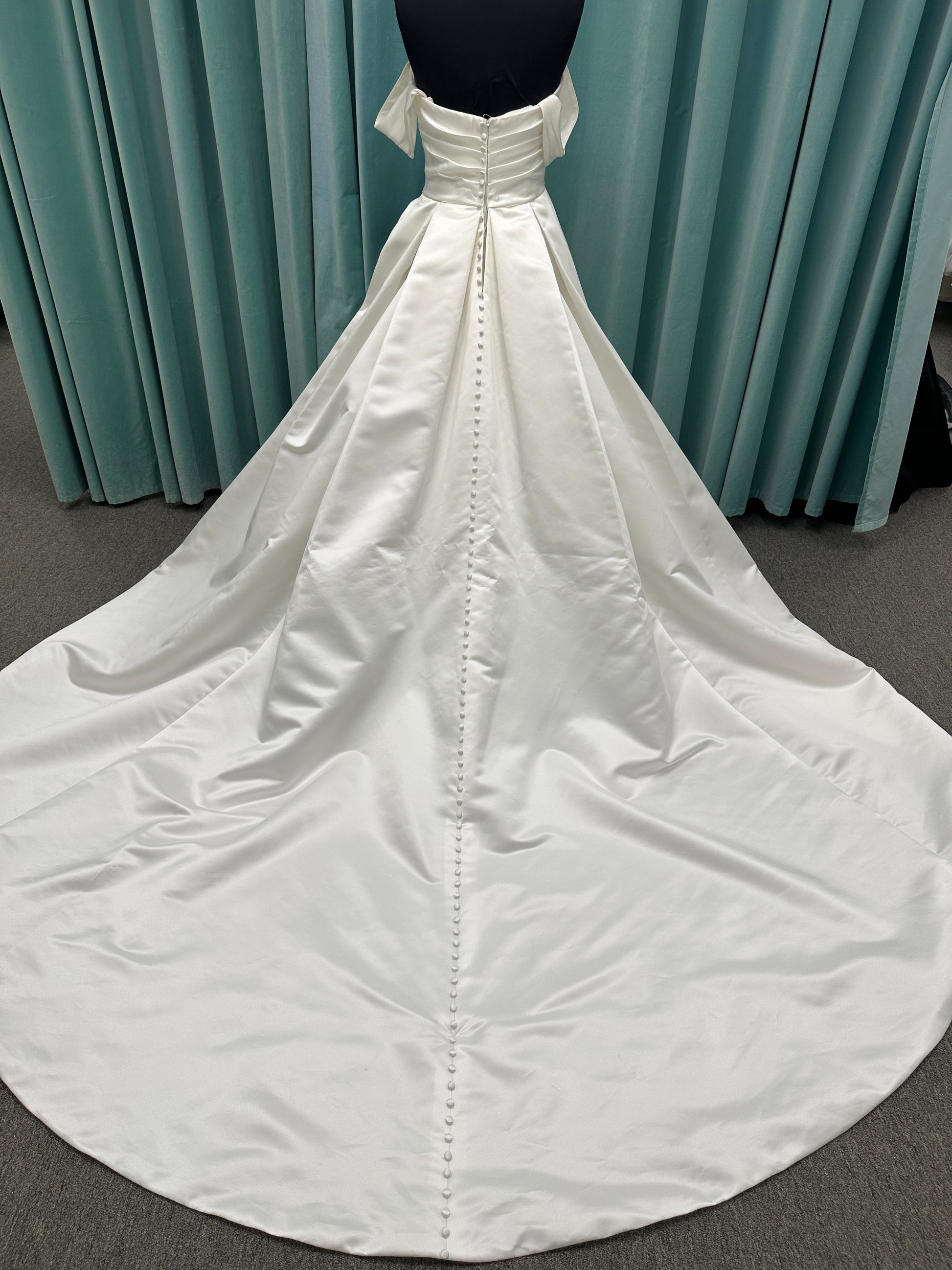 Off-the-shoulder satin A-line wedding dress with detachable straps, leg slit, pockets, and embroidered floral detailing by Essense of Australia style D4187