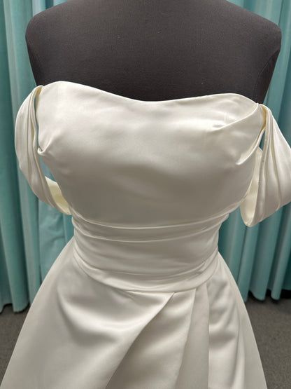 Off-the-shoulder satin A-line wedding dress with detachable straps, leg slit, pockets, and embroidered floral detailing by Essense of Australia style D4187