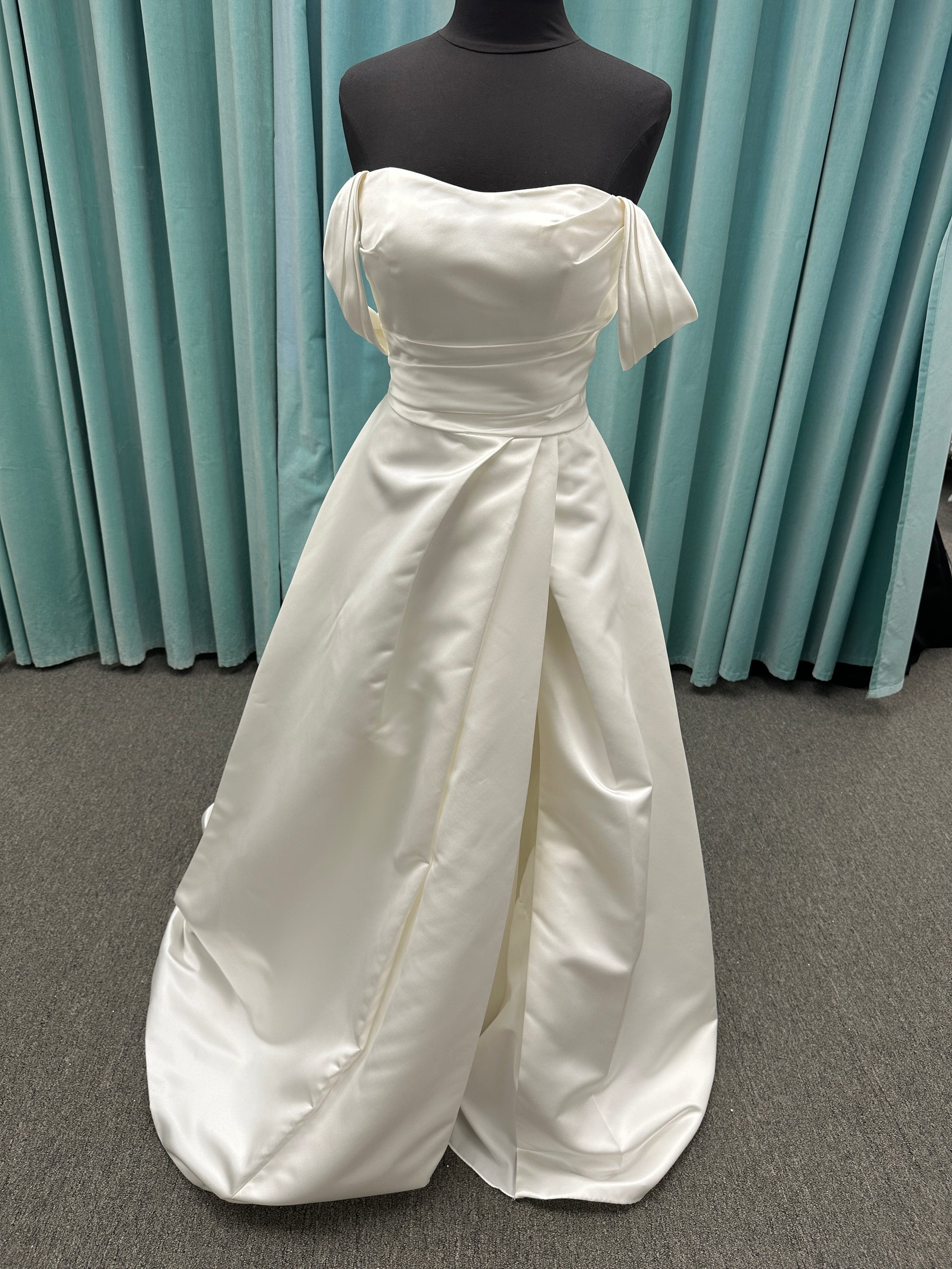 Off-the-shoulder satin A-line wedding dress with detachable straps, leg slit, pockets, and embroidered floral detailing by Essense of Australia style D4187