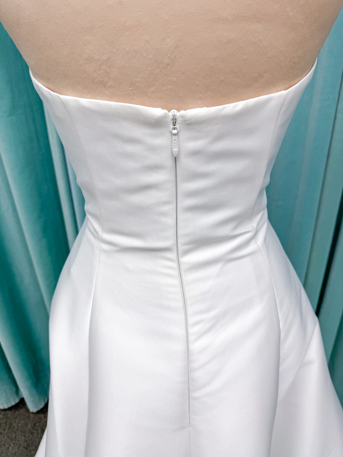 Strapless A-line wedding dress with a scoop neckline, structured drop-waist bodice, clean princess seams, and smooth full skirt.