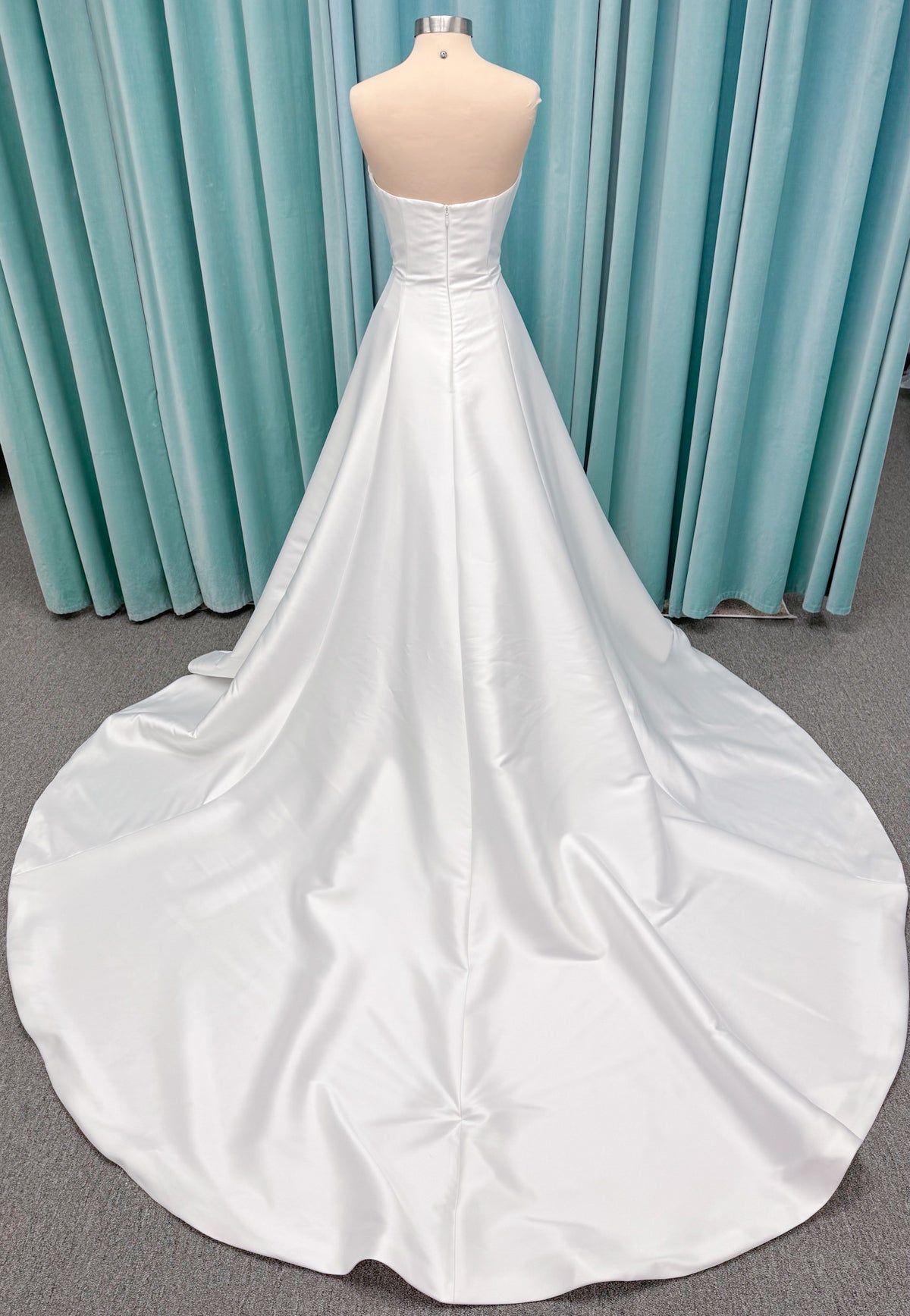 Strapless A-line wedding dress with a scoop neckline, structured drop-waist bodice, clean princess seams, and smooth full skirt.