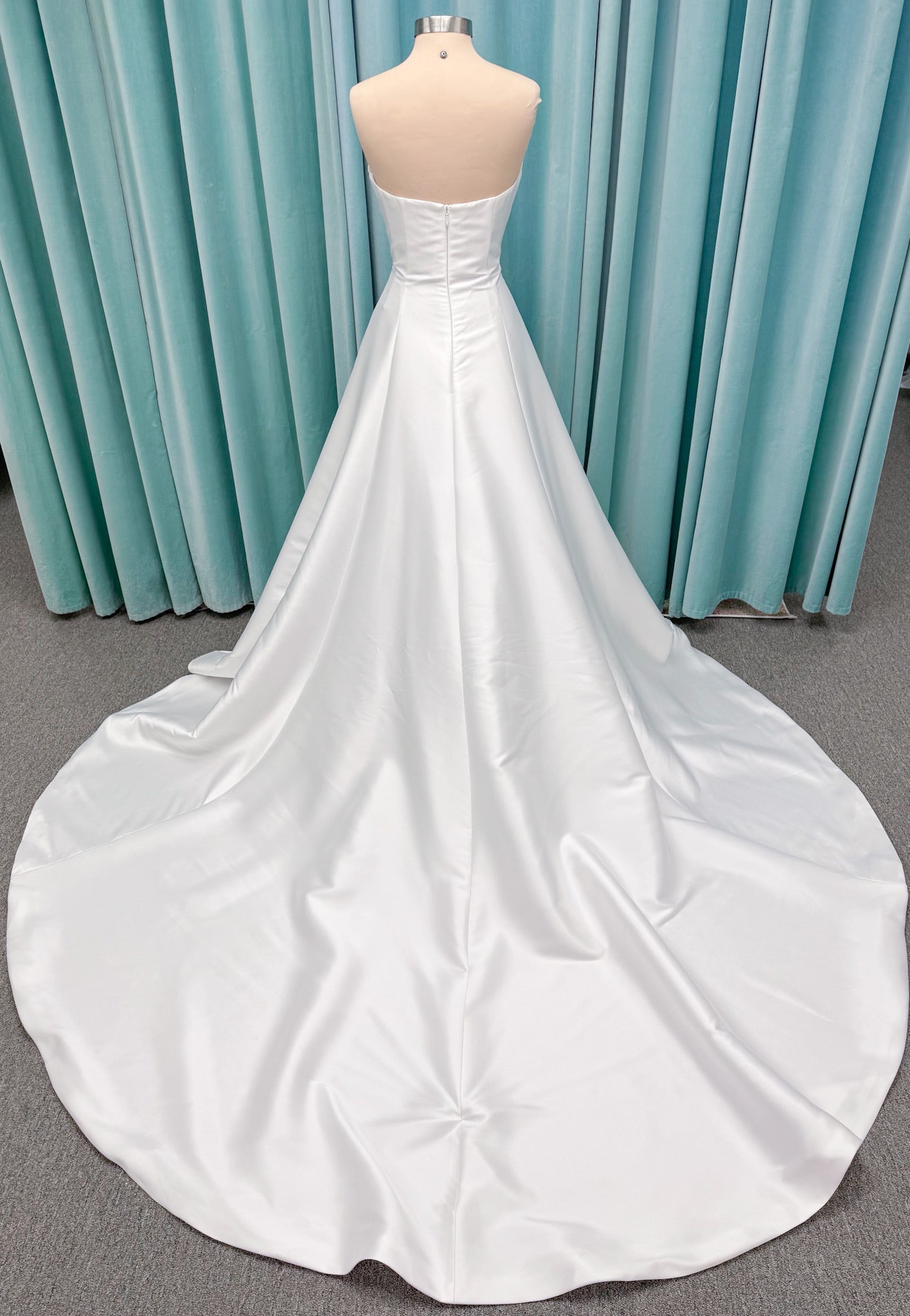 Strapless A-line wedding dress with a scoop neckline, structured drop-waist bodice, clean princess seams, and smooth full skirt.