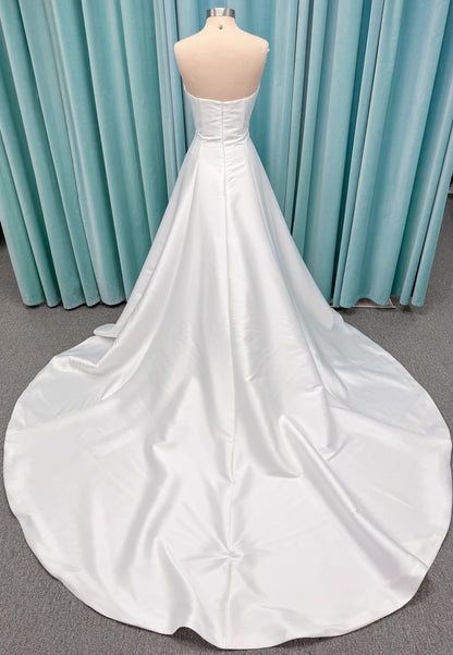 Strapless A-line wedding dress with a scoop neckline, structured drop-waist bodice, clean princess seams, and smooth full skirt.