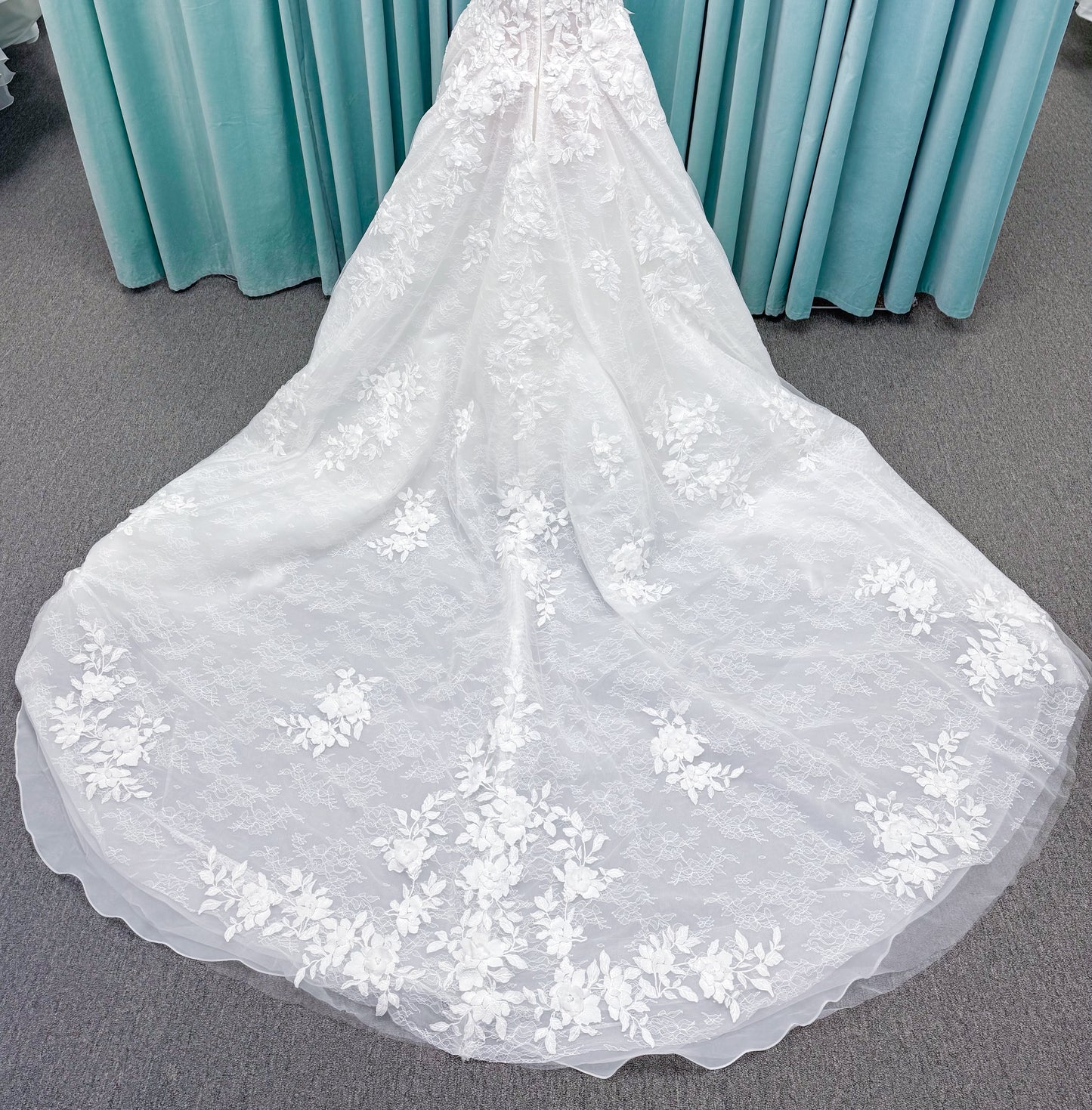 Morilee 1010024 Alina A-line wedding dress on mannequin with strapless basque waist, corset boning, Chantilly lace, and hand-cut taffeta flowers