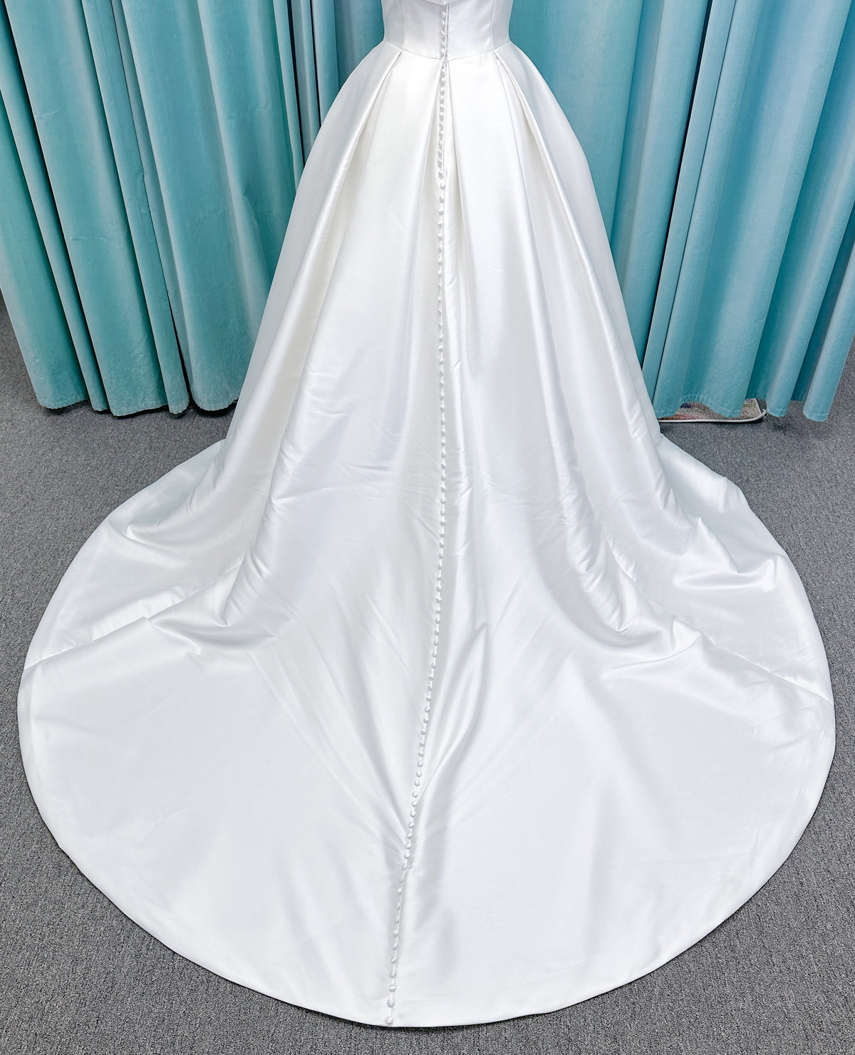 Morilee 1050011 Allegro A-line wedding dress on mannequin with strapless straight neckline, Mikado fabric, box-pleated skirt, and detachable fold-over bow