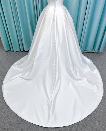 Morilee 1050011 Allegro A-line wedding dress on mannequin with strapless straight neckline, Mikado fabric, box-pleated skirt, and detachable fold-over bow
