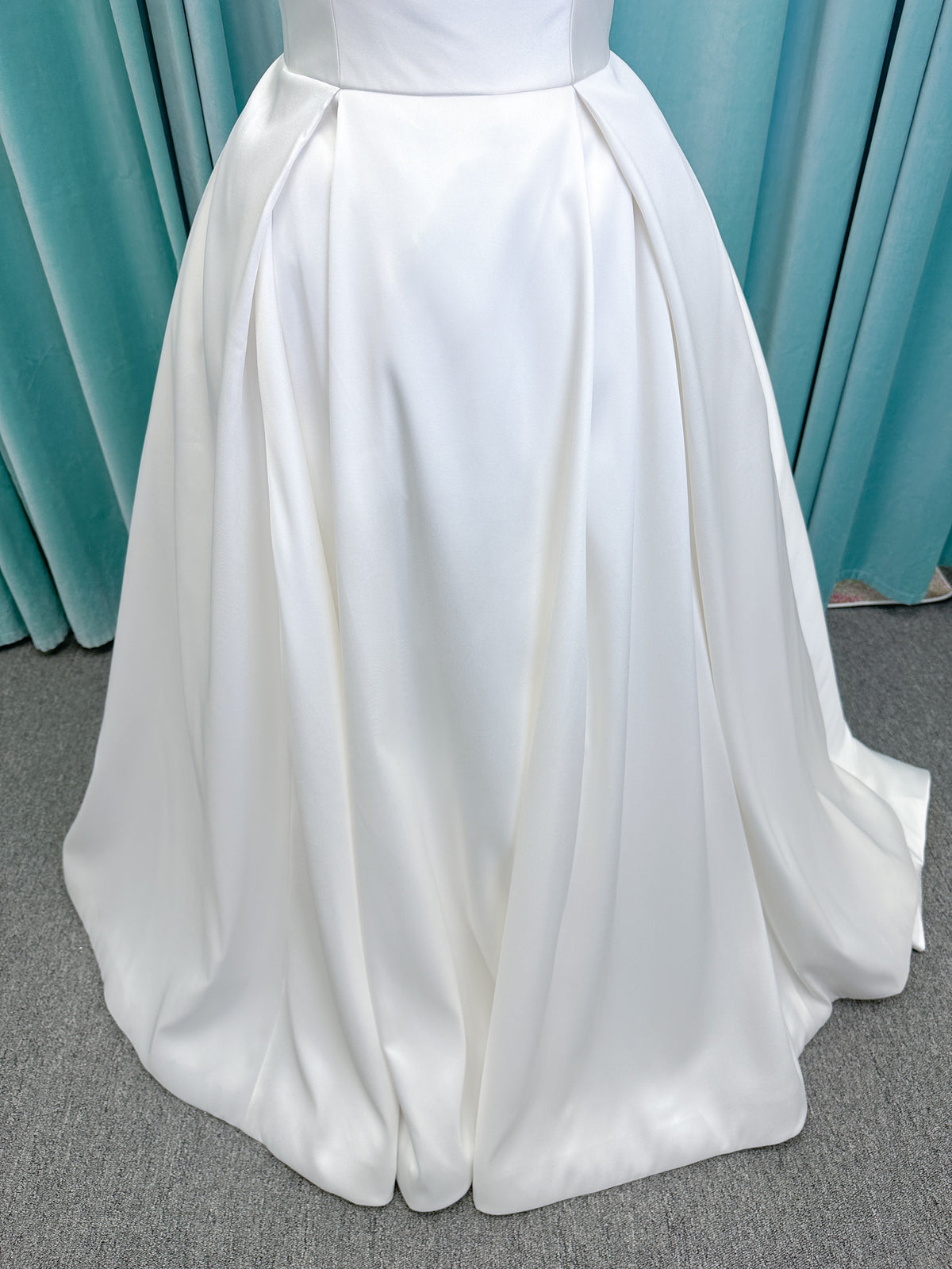 Morilee 1050011 Allegro A-line wedding dress on mannequin with strapless straight neckline, Mikado fabric, box-pleated skirt, and detachable fold-over bow
