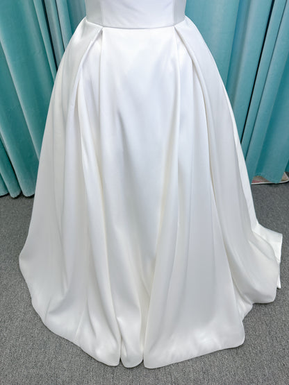 Morilee 1050011 Allegro A-line wedding dress on mannequin with strapless straight neckline, Mikado fabric, box-pleated skirt, and detachable fold-over bow