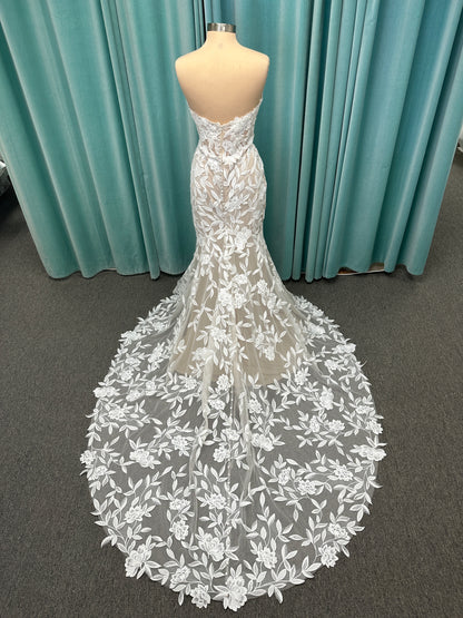 Morilee Santana wedding dress style 2739 featuring strapless sweetheart neckline, floral beaded lace, detachable long sleeves with bow streamers, and fit and flare silhouette