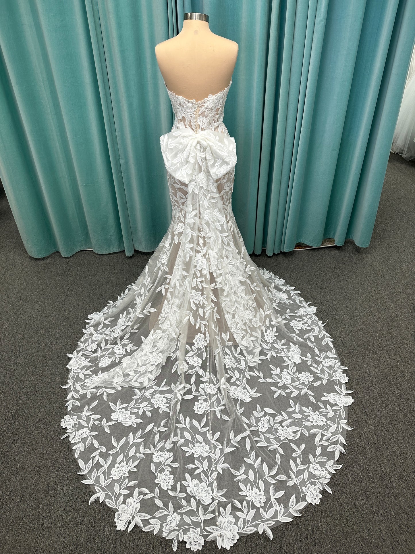 Morilee Santana wedding dress style 2739 featuring strapless sweetheart neckline, floral beaded lace, detachable long sleeves with bow streamers, and fit and flare silhouette