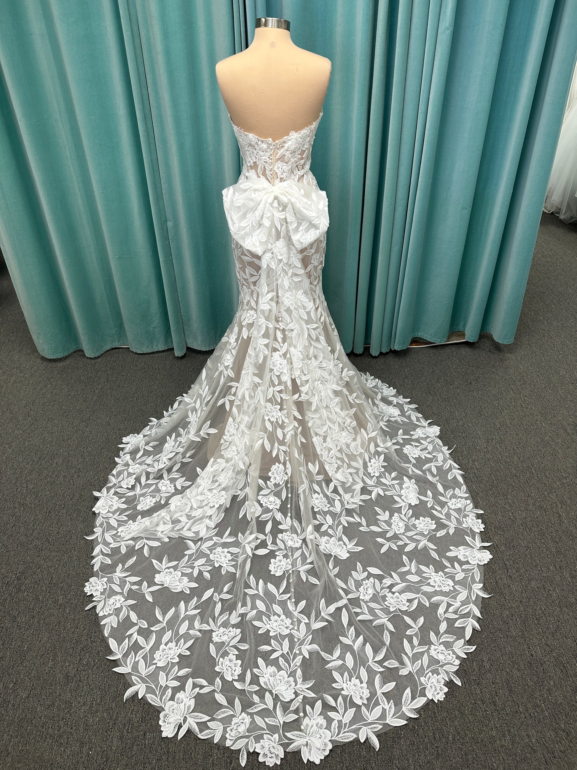 Morilee Santana wedding dress style 2739 featuring strapless sweetheart neckline, floral beaded lace, detachable long sleeves with bow streamers, and fit and flare silhouette