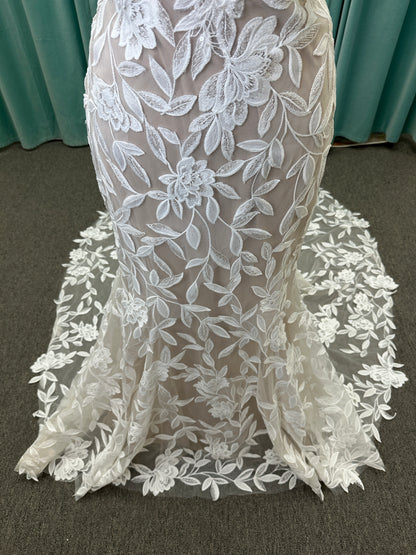 Morilee Santana wedding dress style 2739 featuring strapless sweetheart neckline, floral beaded lace, detachable long sleeves with bow streamers, and fit and flare silhouette