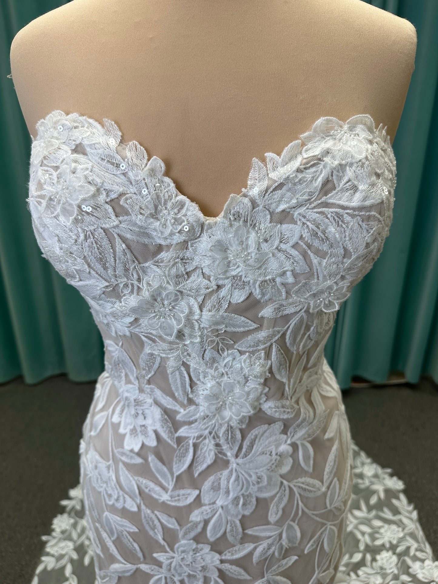 Morilee Santana wedding dress style 2739 featuring strapless sweetheart neckline, floral beaded lace, detachable long sleeves with bow streamers, and fit and flare silhouette