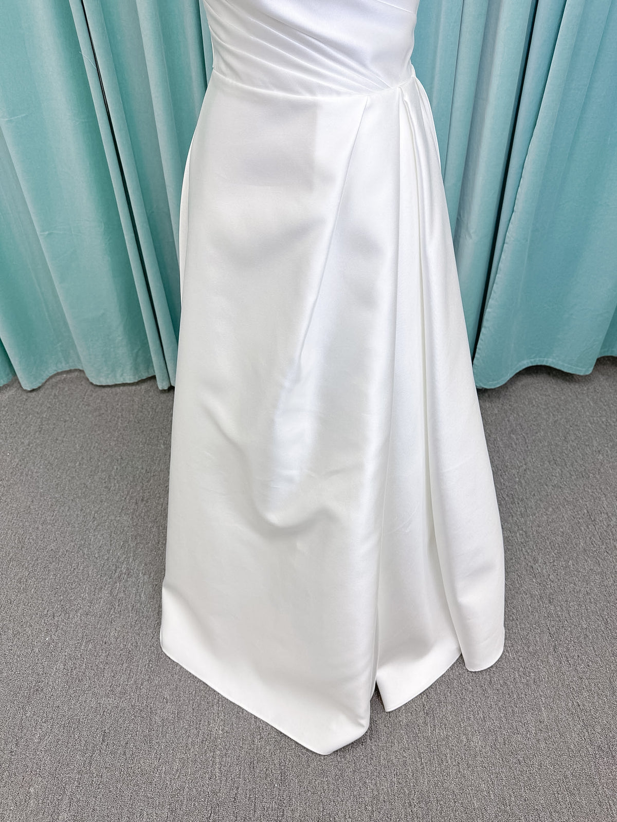 Moonlight Bridal J6852 Artemis A-line wedding dress on mannequin with strapless pointed sweetheart neckline, ruched mikado bodice, natural waist, pleated skirt with front slit, and sweep train