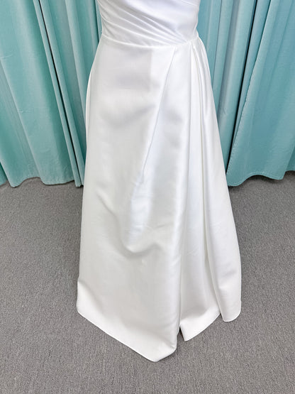 Moonlight Bridal J6852 Artemis A-line wedding dress on mannequin with strapless pointed sweetheart neckline, ruched mikado bodice, natural waist, pleated skirt with front slit, and sweep train