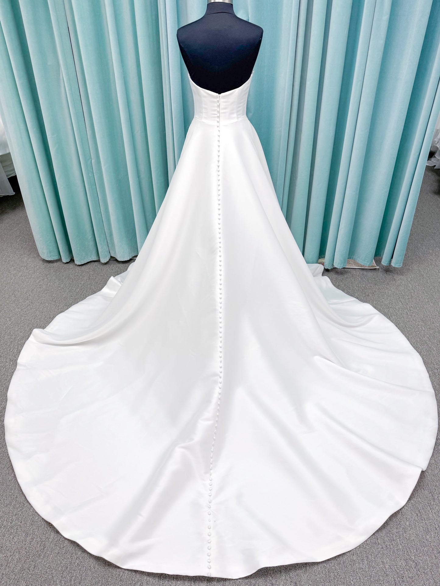 Light Mikado A-line wedding dress with strapless bodice, plunging V-neckline, illusion inset, defined waist, and full skirt.