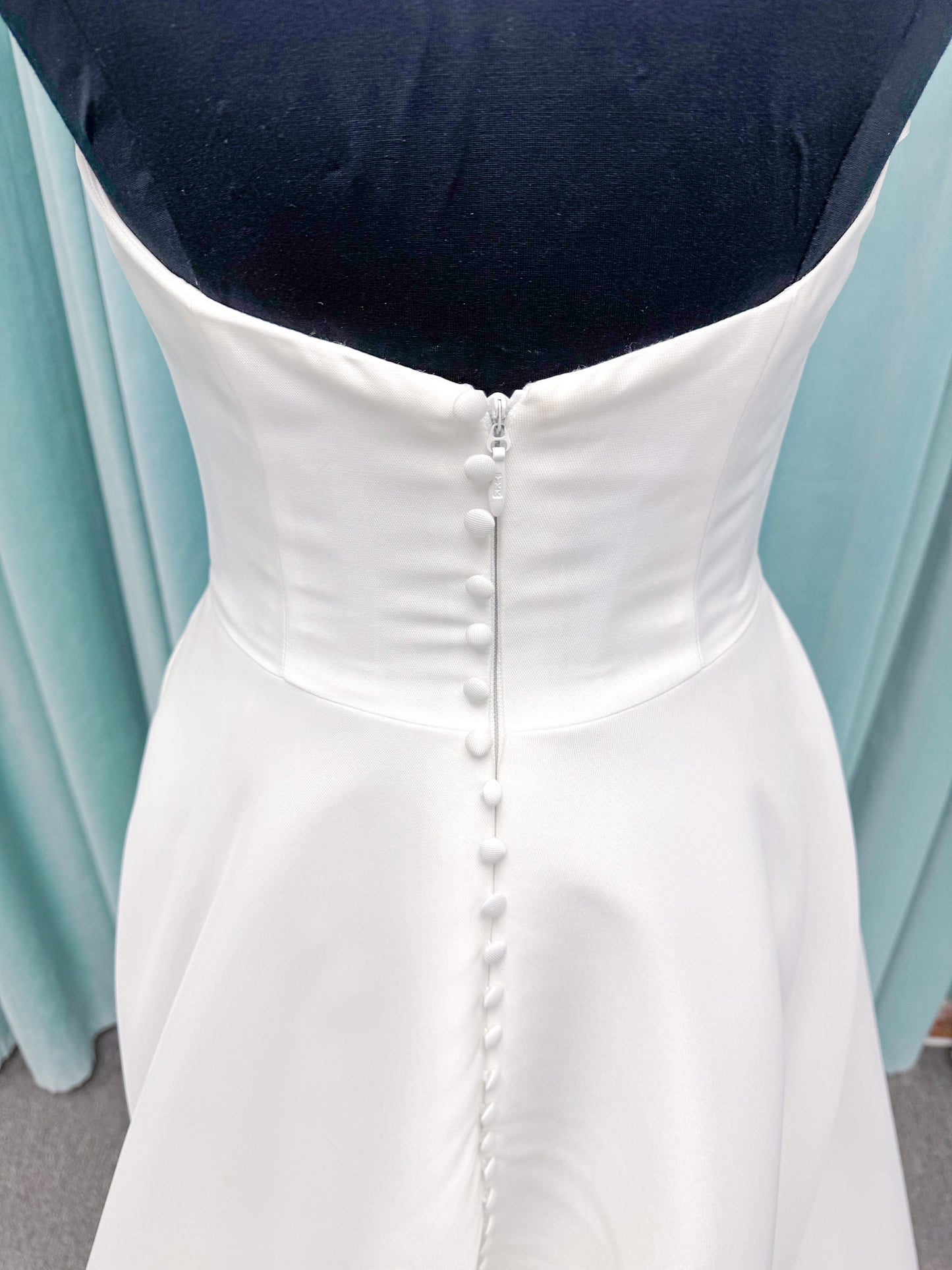 Light Mikado A-line wedding dress with strapless bodice, plunging V-neckline, illusion inset, defined waist, and full skirt.