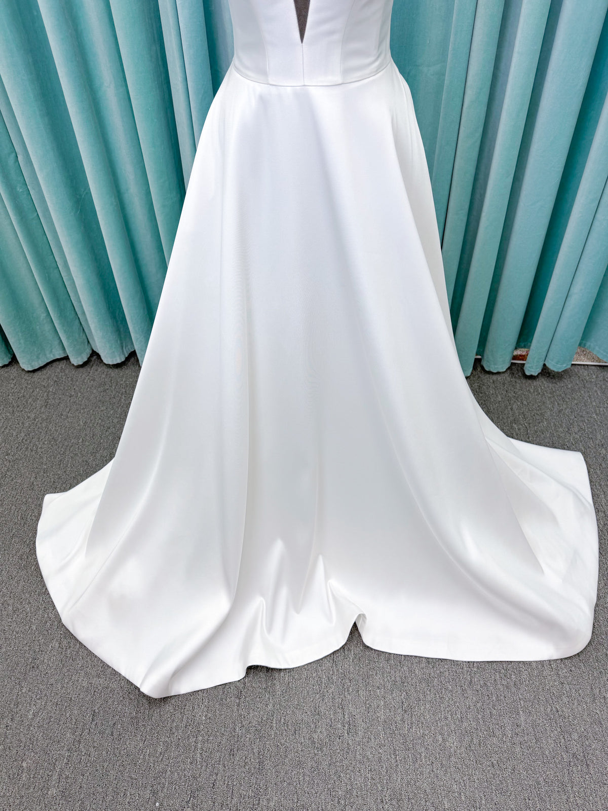 Light Mikado A-line wedding dress with strapless bodice, plunging V-neckline, illusion inset, defined waist, and full skirt.