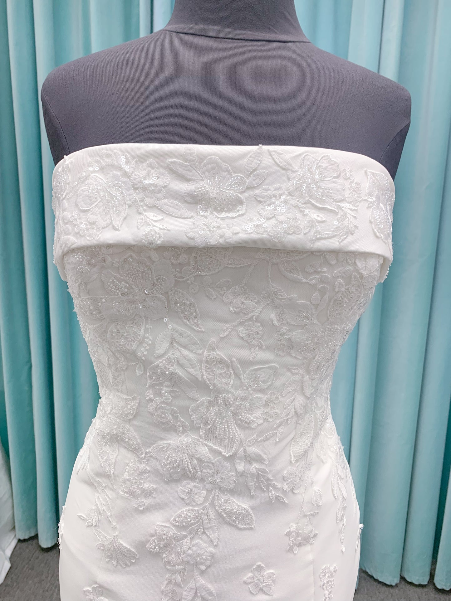Morilee 2905 Atalanta fit and flare wedding dress in stretch Mikado with fold-over strapless neck, beaded lace bodice, and detachable double-loop embellished bow.