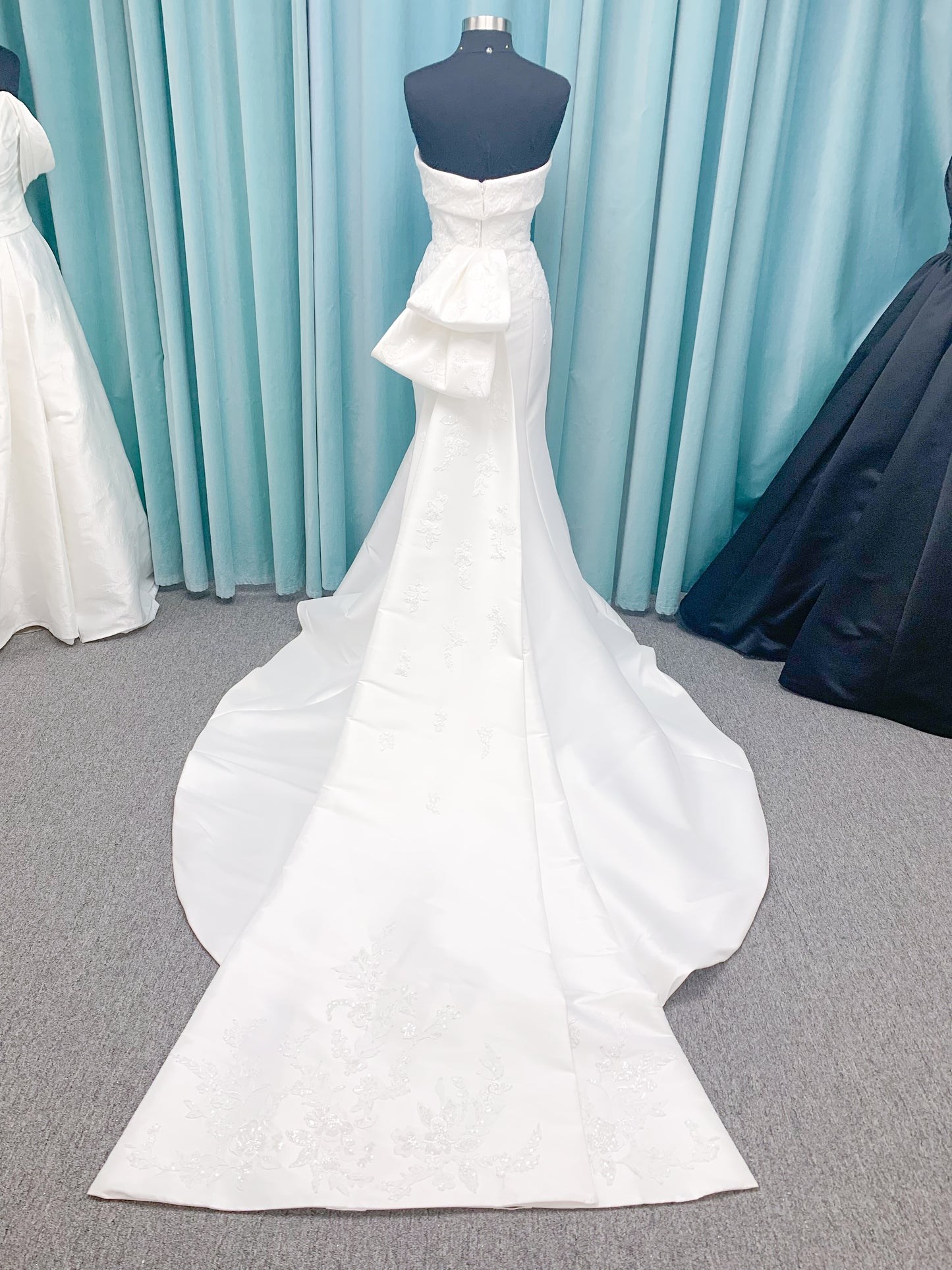 Morilee 2905 Atalanta fit and flare wedding dress in stretch Mikado with fold-over strapless neck, beaded lace bodice, and detachable double-loop embellished bow.