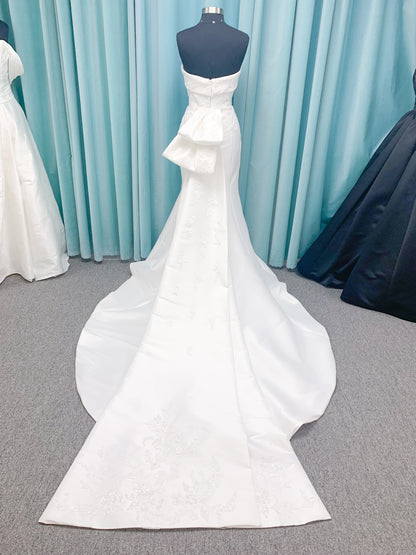 Morilee 2905 Atalanta fit and flare wedding dress in stretch Mikado with fold-over strapless neck, beaded lace bodice, and detachable double-loop embellished bow.