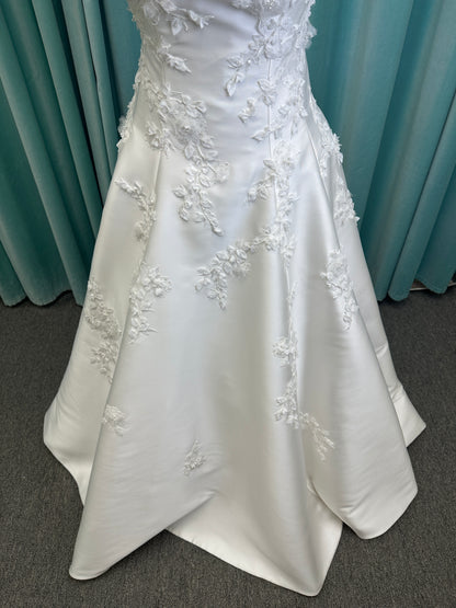 Essense of Australia D4195 ivory lace and Mikado drop-waist wedding dress on mannequin with strapless square neckline, 3D appliqué bodice, and A-line skirt.
