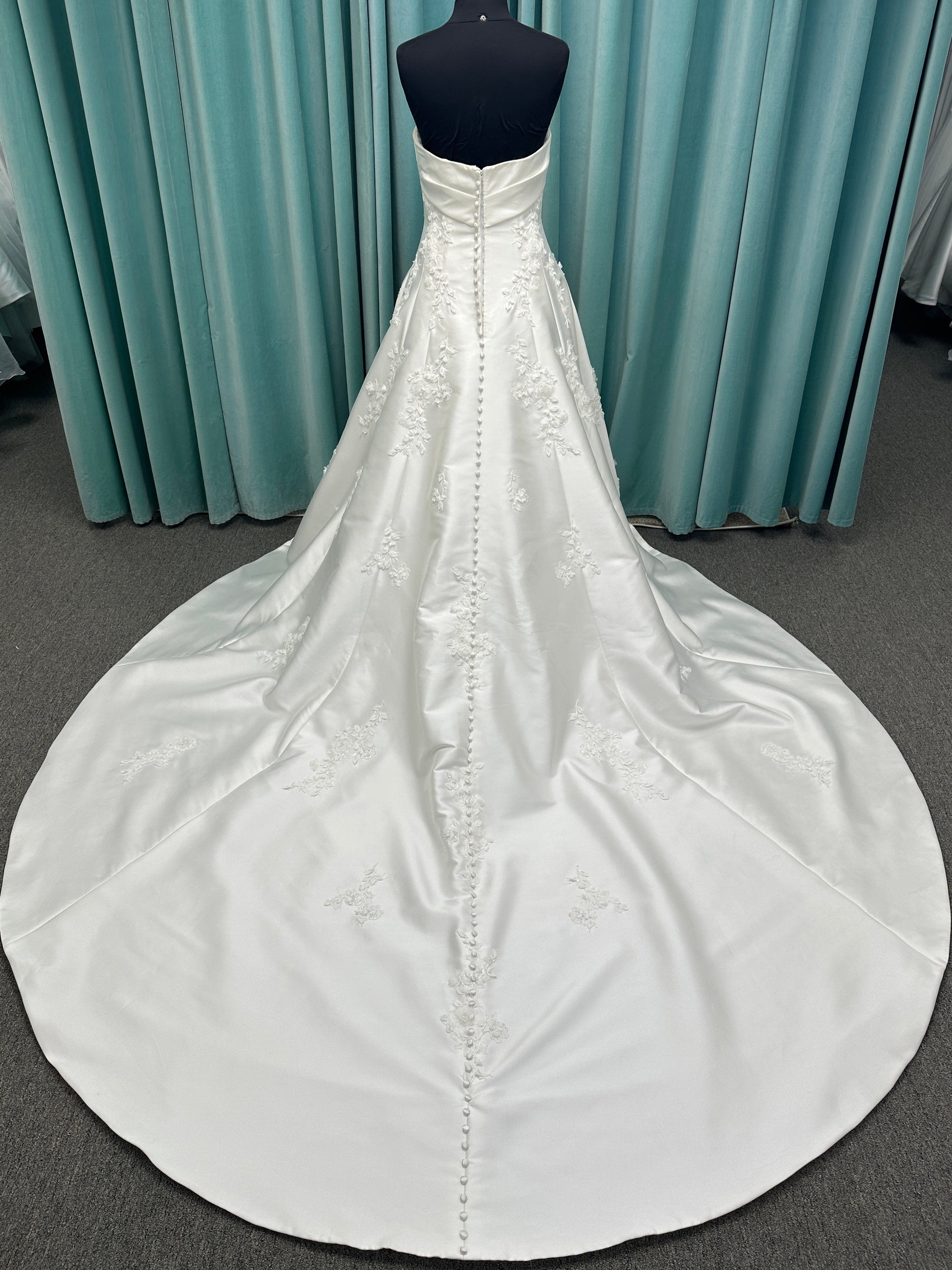 Essense of Australia D4195 ivory lace and Mikado drop-waist wedding dress on mannequin with strapless square neckline, 3D appliqué bodice, and A-line skirt.
