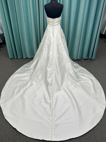 Essense of Australia D4195 ivory lace and Mikado drop-waist wedding dress on mannequin with strapless square neckline, 3D appliqué bodice, and A-line skirt.
