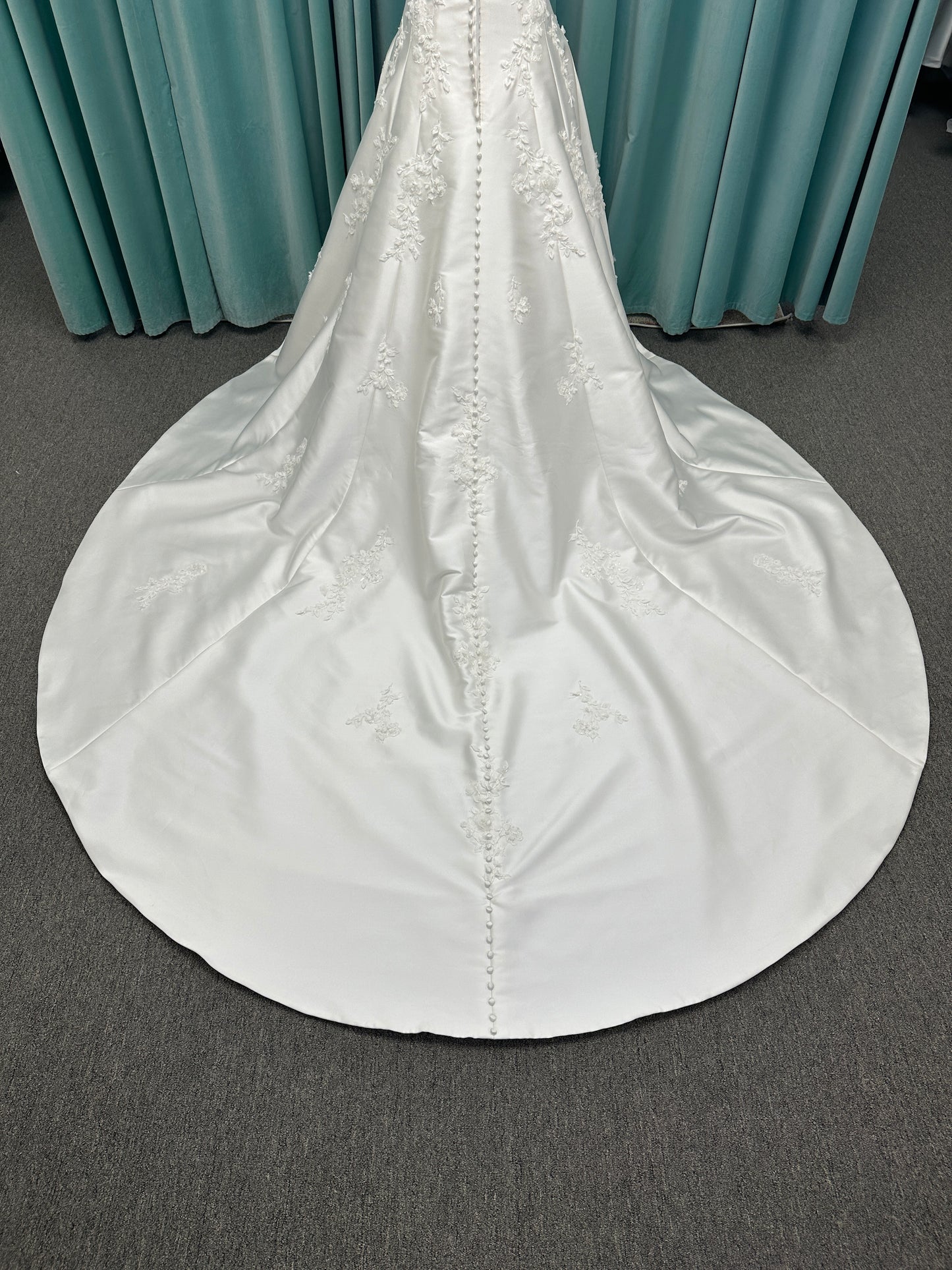 Essense of Australia D4195 ivory lace and Mikado drop-waist wedding dress on mannequin with strapless square neckline, 3D appliqué bodice, and A-line skirt.

