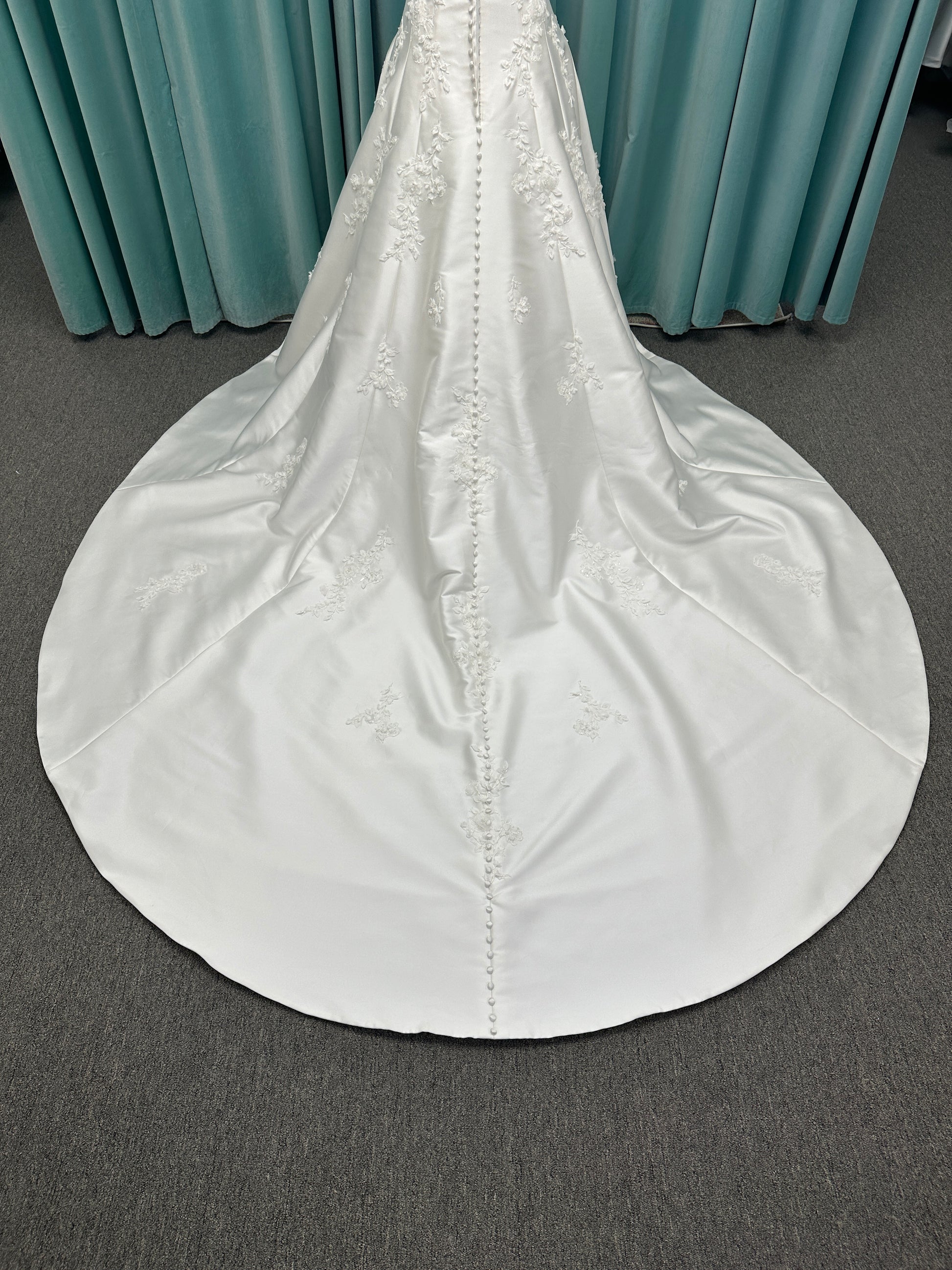 Essense of Australia D4195 ivory lace and Mikado drop-waist wedding dress on mannequin with strapless square neckline, 3D appliqué bodice, and A-line skirt.

