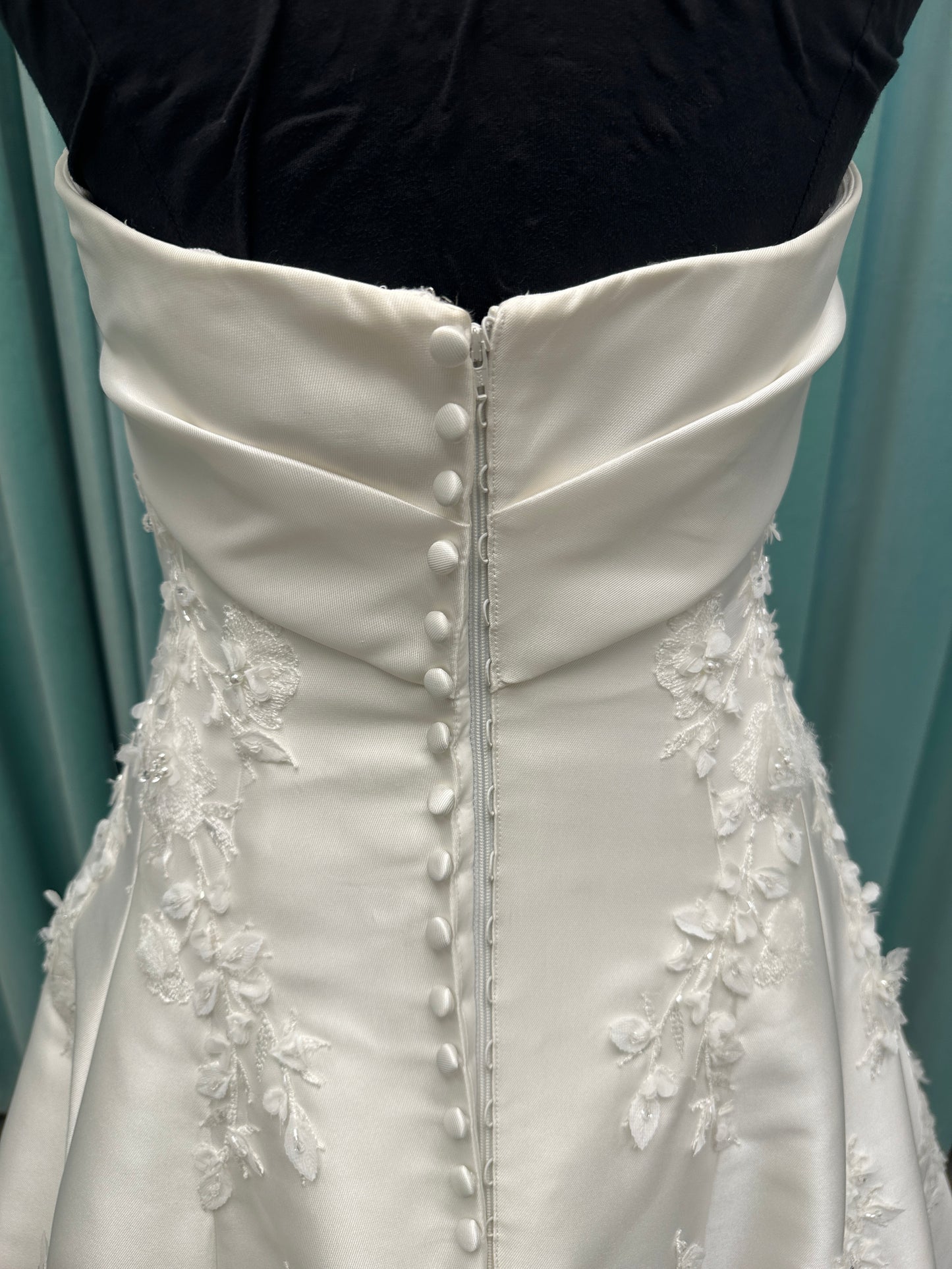 Essense of Australia D4195 ivory lace and Mikado drop-waist wedding dress on mannequin with strapless square neckline, 3D appliqué bodice, and A-line skirt.
