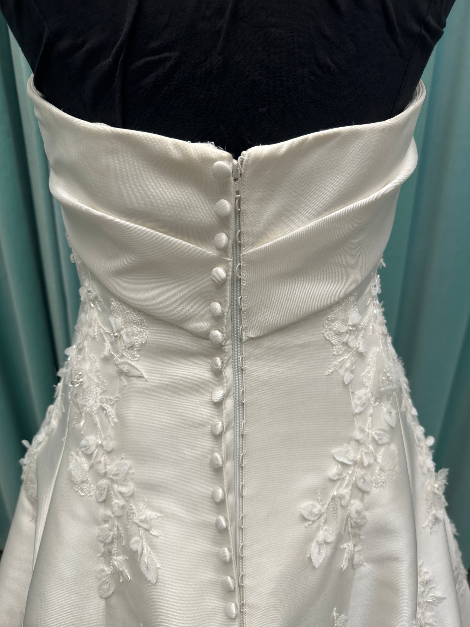 Essense of Australia D4195 ivory lace and Mikado drop-waist wedding dress on mannequin with strapless square neckline, 3D appliqué bodice, and A-line skirt.
